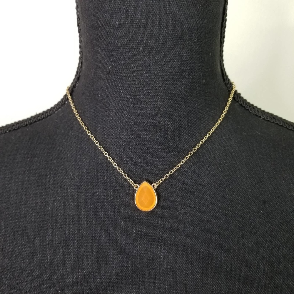 Gold colored necklace with teardrop